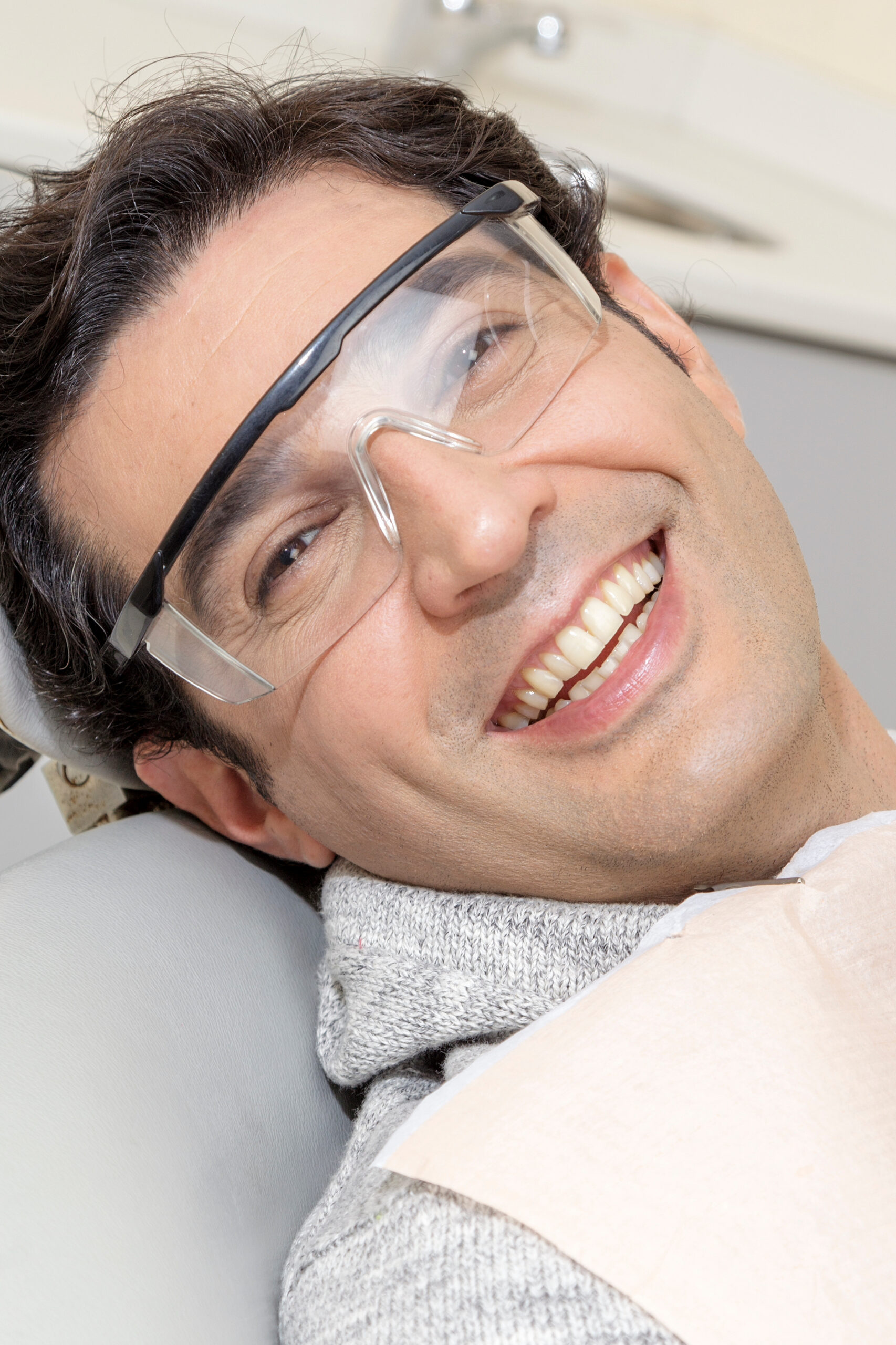 Young man sitting at the chair in dental office