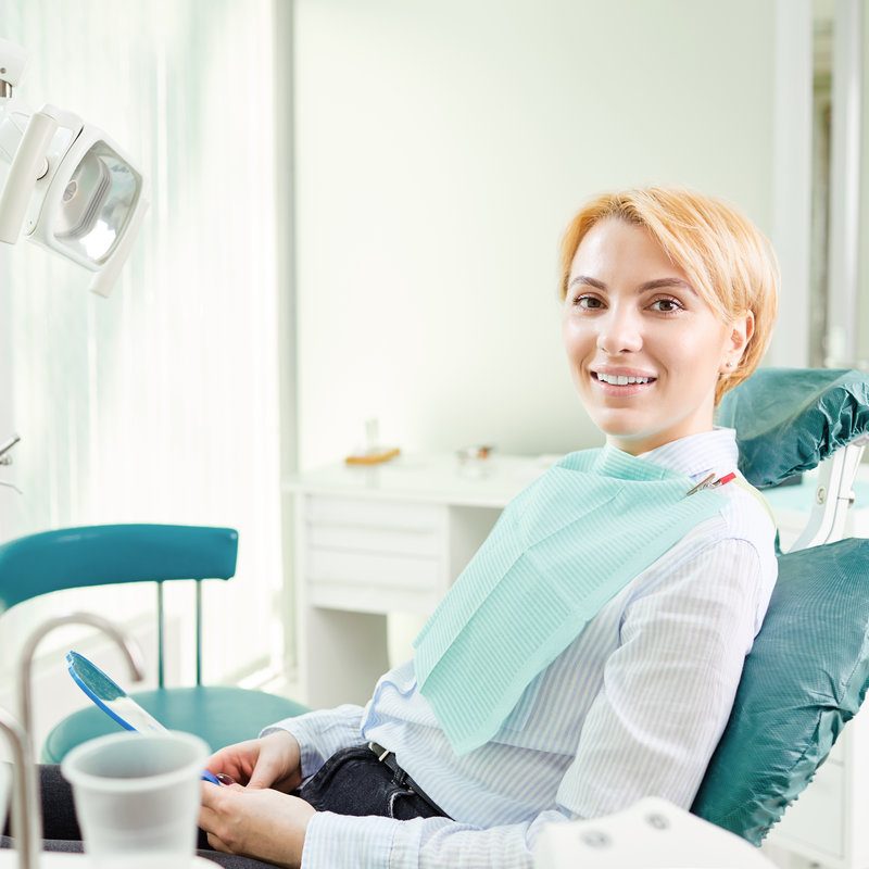 Happy girl patient in the dentist chair.Happy girl patient in the dentist chair.Happy girl patient in the dentist chair.